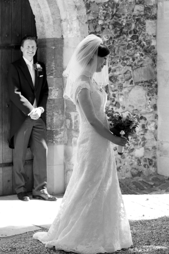 Proud groom looks on